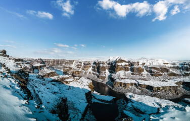 Huge deep canyon and river under blue sky