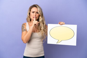 Young Brazilian woman isolated on purple background holding a placard with speech bubble icon doing silence gesture