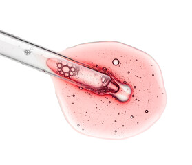 Liquid red pink retinol or vitamin c gel or serum with a dropper on a screen of microscope white isolated background