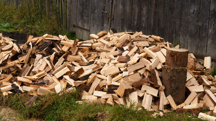 Chopped firewood stacked on a pile. preparation of fuel for heating in winter