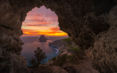 Arch in the cave with Es Vedra Island at sunset , Ibiza