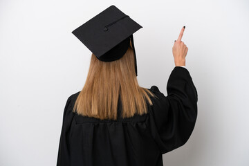 Young university graduate English woman isolated on white background pointing back with the index finger