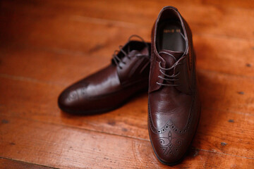 brown leather italian classic shoes close-up on wooden parquet
