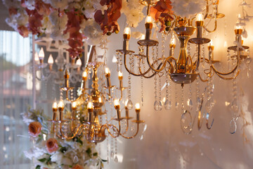 vintage gilded chandeliers scarcely glowing with warm light