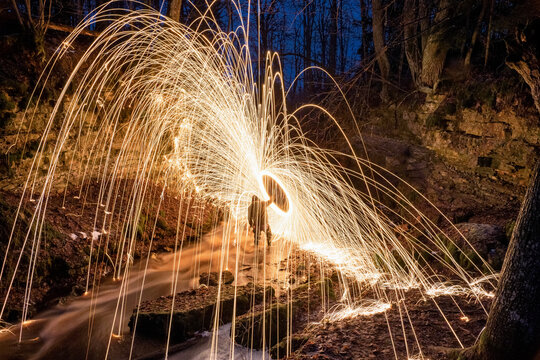 Burning steel wool spinned. Showers of glowing sparks from spinning steel wool