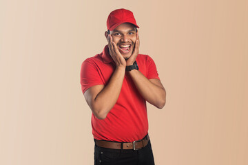 deliver man smiling with a happy, confident expression with hand on chin