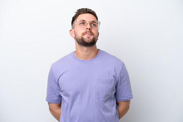 Fototapeta premium Young caucasian man isolated on white background and looking up