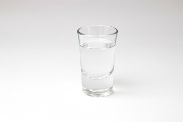 Shot with transparent liquid alcohol on a white background