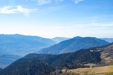 Mountain landscapes with peaks and valleys with plants and blue sky. A sunny day is good for a trip to the mountains and adventures