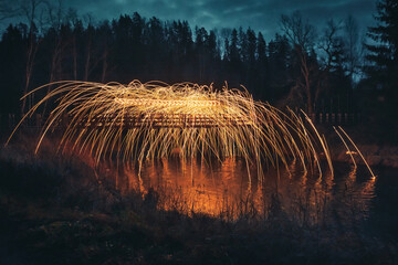 Burning steel wool spinned. Showers of glowing sparks from spinning steel wool