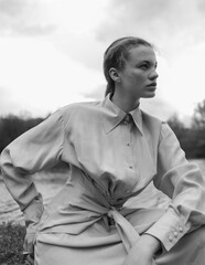 Fototapeta premium Fashion portrait of a beautiful and cute girl in nature in stylish clothes