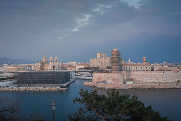 Sunset and night view over Cathedral, Fort and Mucem buildings in Marseille harbour, France