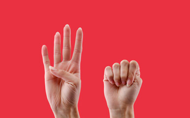 Gestural sign of help male violence on red background