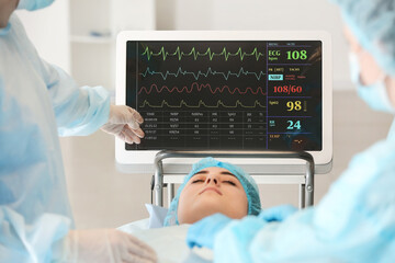 Team of surgeons operating patient in clinic