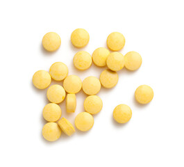 Yellow pills on white background