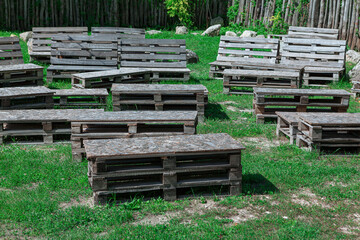 Wooden seats on the grass . Outdoor benches at nature