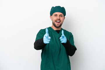 Surgeon in green uniform isolated on white background pointing to the front and smiling