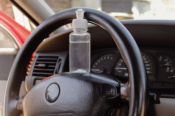  The disinfectant is on the steering wheel of the car. covid-19 concept