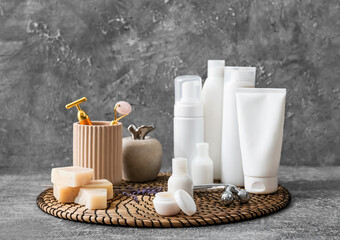 Set of different cosmetic products and tools on grunge background