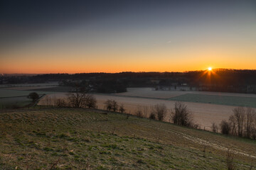 Sunrise over the Jeker valley with the vineyards near Maastricht with a view on the country border and the  typical rolling hills landscape which this area is famous for.