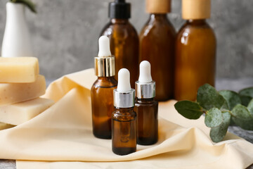Bottles of essential oil on table, closeup