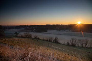 Sunrise over the Jeker valley with the vineyards near Maastricht with a view on the country border and the  typical rolling hills landscape which this area is famous for.