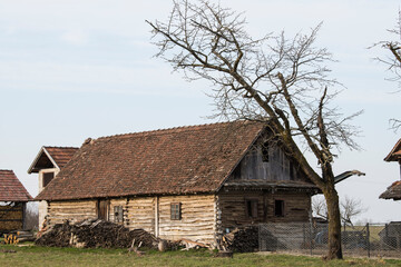 Fototapeta na wymiar Sunja, Croatia, April 20,2021 :Abandoned traditional old wooden house. 
