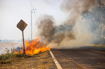 Views of blazes, burning hay, producing black clouds of black smoke.