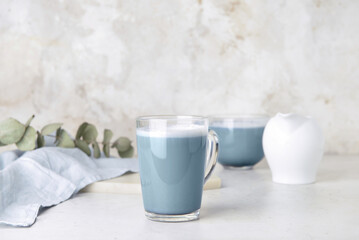 Glass cup of delicious Charcoal Latte on light table