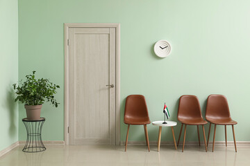 Interior of modern hall with chairs and UAE flag