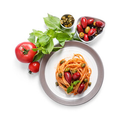 Plate with tasty Pasta Puttanesca, ingredients and basil on white background