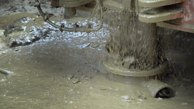 Closeup of drill in the process of drilling a water well with a winding drill, construction site concept