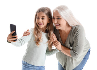 Little girl with her grandmother taking selfie on white background