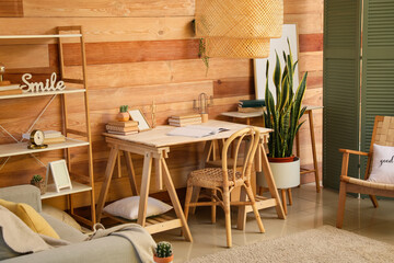 Interior of stylish living room with modern workplace, houseplants and wooden wall