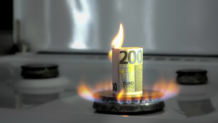 Concept of gas crisis. 200 euro bill is burning on a kitchen stove burner. European cash money. High prices of natural resources. Fire flame. Utility debt. Energy war. Saving home budget. Finance - obrazy, fototapety, plakaty