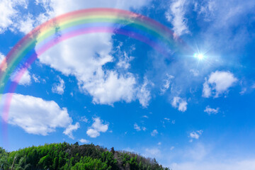 Obraz na płótnie Canvas Bright blue sky with rainbow and sunshine_wide_26
