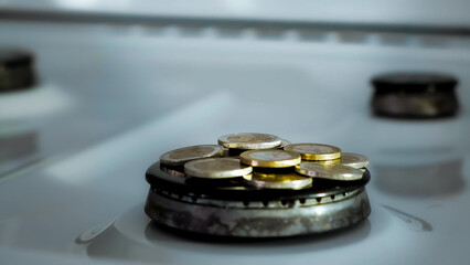 Concept of gas crisis. 2 Euro coins is burning on a kitchen stove burner and fall when the gas end. High prices of natural resources. Fire flame. Utility debt. Energy war. Saving home budget. Finance