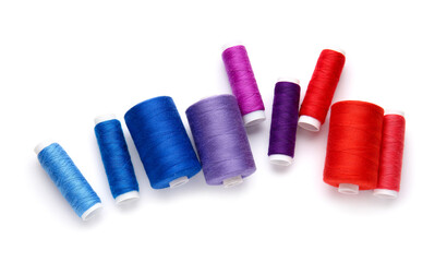 Different thread spools on white background