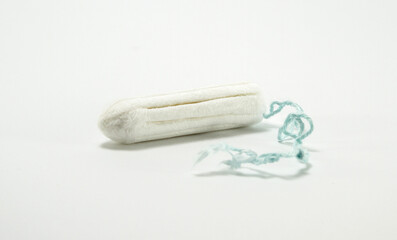 Fototapeta na wymiar Hygienic cotton tampon, unwrapped on white background.