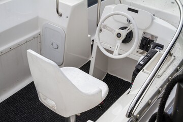 Empty cockpit in a motorboat. Speedboat dashboard with steering wheel throttle lever.