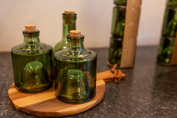 Unusual green bottles with corks stand on a wooden stand