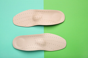 Orthopedic insoles on color background