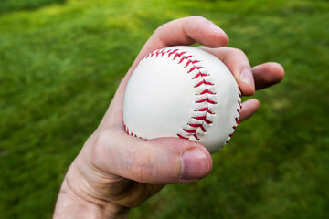 Baseball player gripping a ball. Pitcher hand holding a baseball ready to pitch.