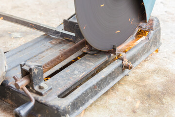 Mechanic is cutting steel with splashes of sparks