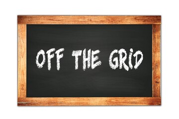 Fototapeta premium OFF THE GRID text written on wooden frame school blackboard.