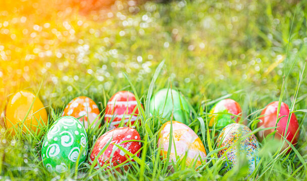 Abstract Defocused Easter, Closeup, many beautiful painted eggs as grass blurred background. concept for good friday, easter monday. copy space on top for design. garden, nobody