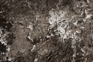 Dirty rustic grunge textured surface of an old abandoned stone wall for background