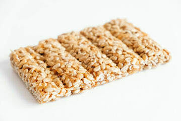 Delicious sweet kozinaki pieces on white wooden table