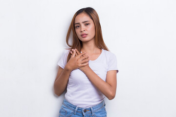 Young beautiful asian woman having heart attack isolated on white background
