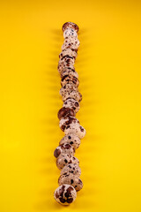 image with eggs of (Coturnix coturnix), on Yellow background